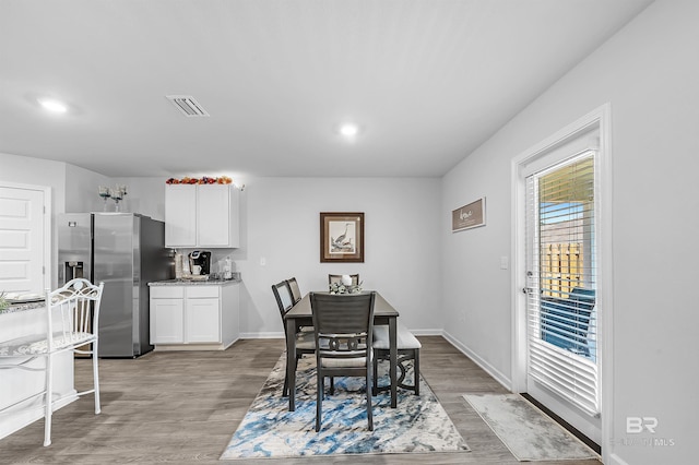 dining space with light hardwood / wood-style flooring