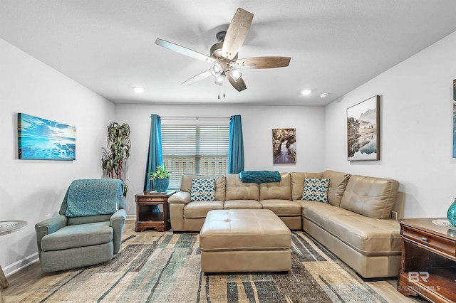 living room with ceiling fan and hardwood / wood-style floors