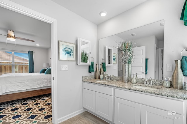 bathroom featuring ceiling fan and dual bowl vanity