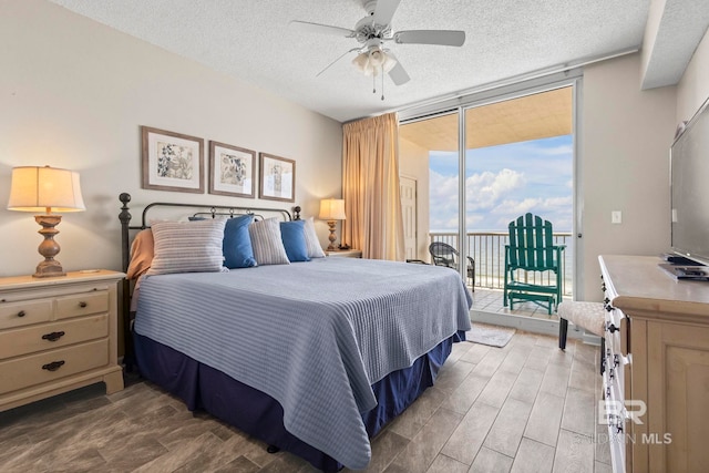 527 Beach Club Trl Unit C908, Gulf Shores, AL 36542 - bedroom with access to outside, a textured ceiling, floor to ceiling windows, and light wood-style flooring