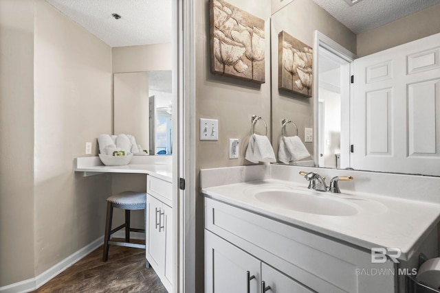 527 Beach Club Trl Unit C908, Gulf Shores, AL 36542 - bathroom with baseboards, a textured ceiling, wood finished floors, and vanity