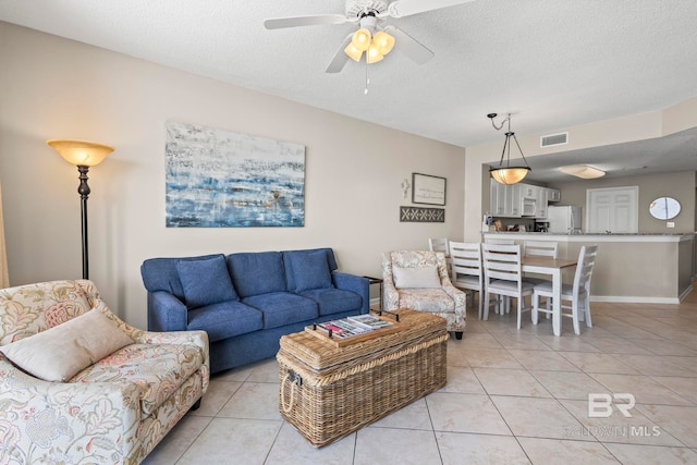 527 Beach Club Trl Unit C908, Gulf Shores, AL 36542 - living room featuring a ceiling fan, a textured ceiling, visible vents, and light tile patterned floors