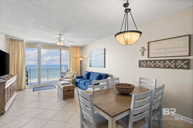 527 Beach Club Trl Unit C908, Gulf Shores, AL 36542 - dining room featuring a ceiling fan, a textured ceiling, and a water view