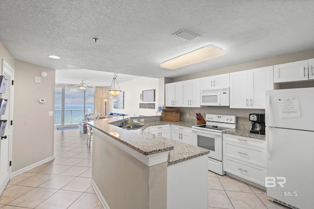 527 Beach Club Trl Unit C908, Gulf Shores, AL 36542 - kitchen featuring white cabinets, a sink, white appliances, a peninsula, and visible vents