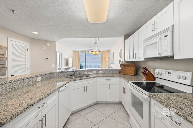 527 Beach Club Trl Unit C908, Gulf Shores, AL 36542 - kitchen with light tile patterned flooring, white appliances, a textured ceiling, white cabinets, and a sink