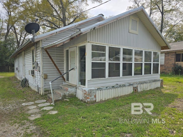 206 E Granberry St, Brewton, AL 36426 - view of side of property with a sunroom, a yard, and entry steps