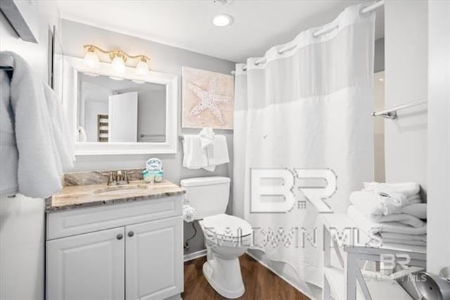 full bath featuring toilet, curtained shower, wood finished floors, and vanity