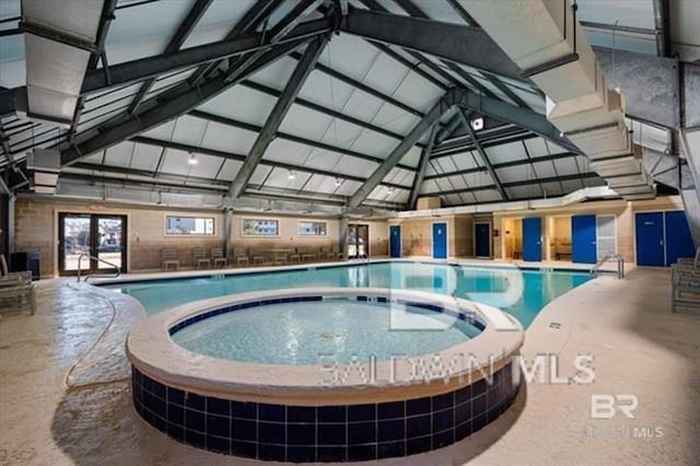 community pool featuring an indoor hot tub and french doors