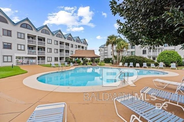 community pool featuring a gazebo and a patio area