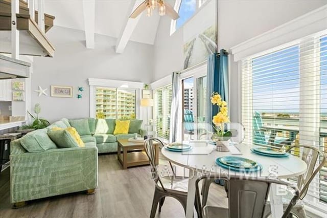 sunroom / solarium with lofted ceiling with beams and ceiling fan