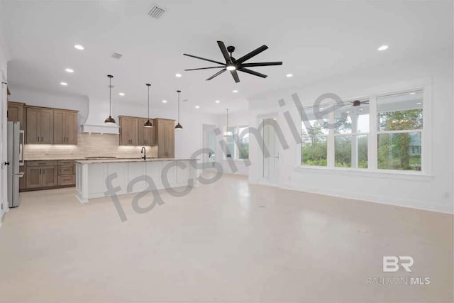 unfurnished living room featuring ceiling fan