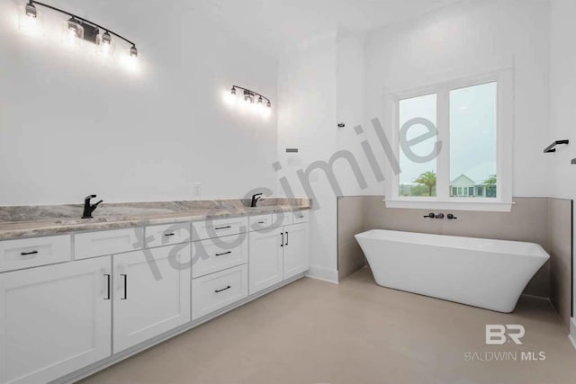 bathroom with vanity and a washtub