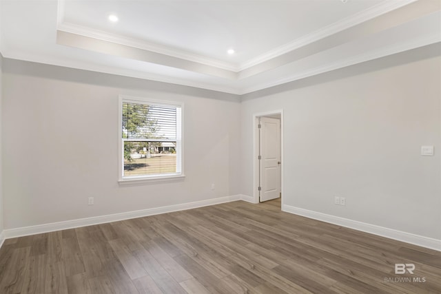 1061 Tampa Ave, Foley, AL 36535 - empty room featuring a tray ceiling, wood finished floors, crown molding, baseboards, and recessed lighting