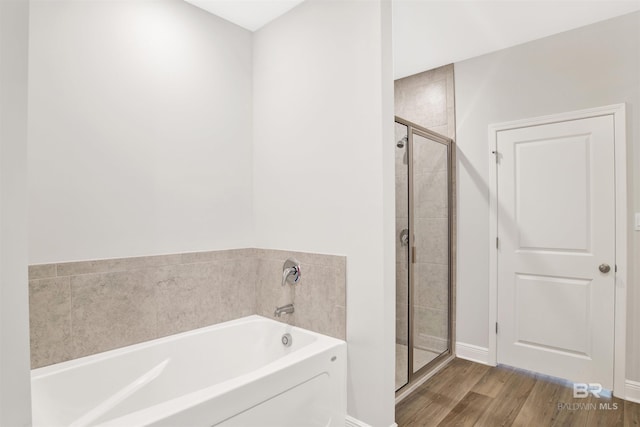 1061 Tampa Ave, Foley, AL 36535 - full bathroom with a garden tub, a shower stall, wood finished floors, and baseboards