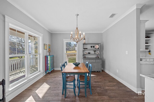 dining room featuring a chandelier, visible vents, ornamental molding, and dark wood-style flooring