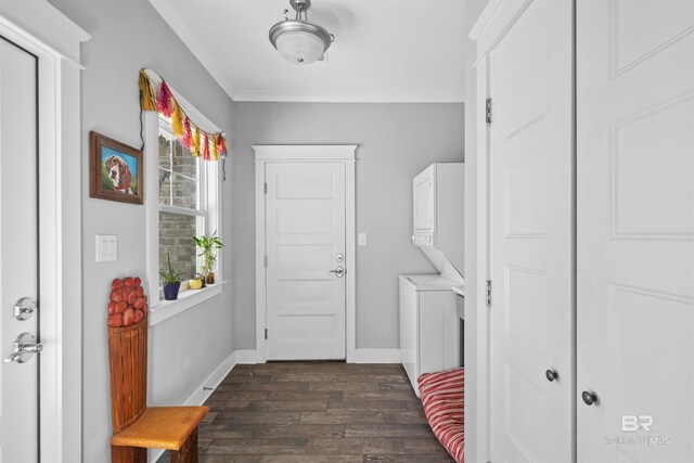 interior space with stacked washer / drying machine, baseboards, dark wood-style floors, and crown molding