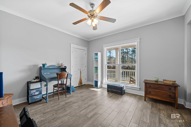 home office featuring ceiling fan, crown molding, baseboards, and wood finished floors