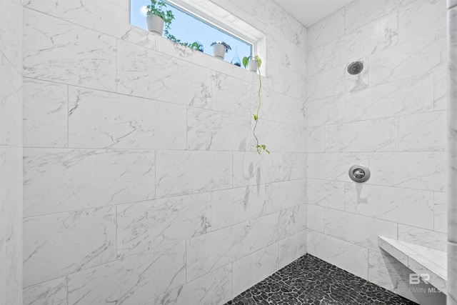 full bath featuring tiled shower