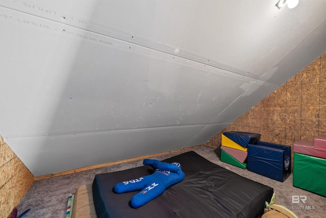 carpeted bedroom with vaulted ceiling