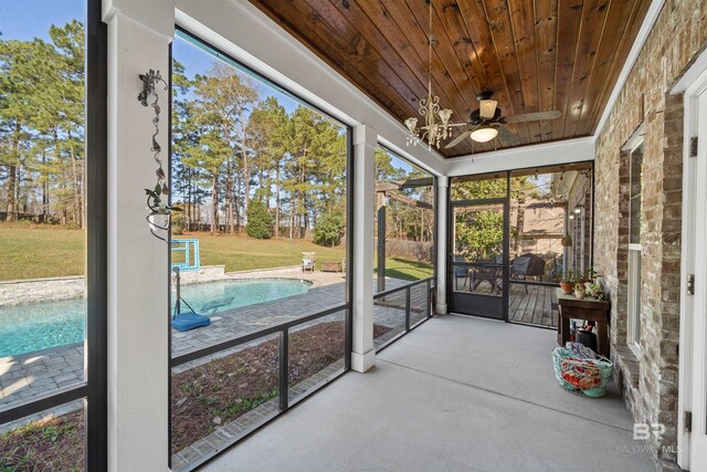 sunroom featuring wooden ceiling and ceiling fan