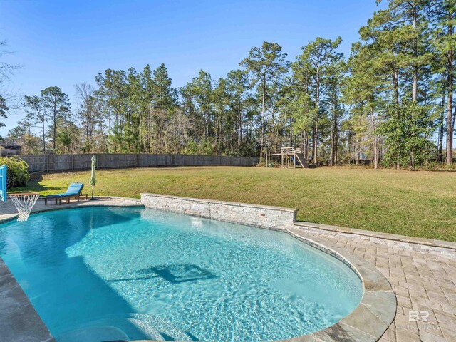 view of pool with a playground, a lawn, a fenced in pool, and a fenced backyard