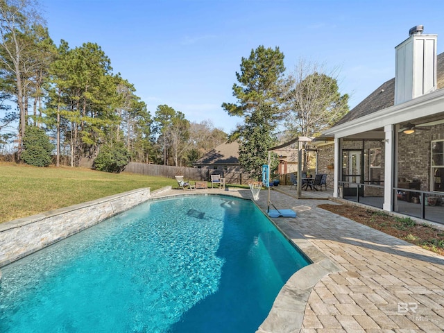 view of pool with a ceiling fan, a patio, a fenced backyard, a yard, and a fenced in pool