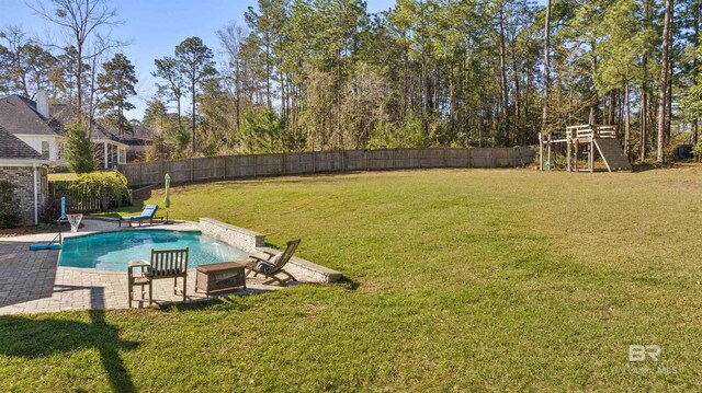 view of swimming pool featuring a patio area, a lawn, a fenced in pool, and a fenced backyard