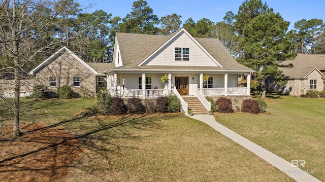 view of front of property featuring a porch, a shingled roof, a front yard, and board and batten siding