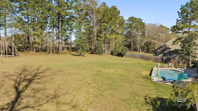 view of yard with a fenced in pool and fence