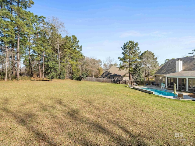 view of yard featuring a fenced in pool and fence