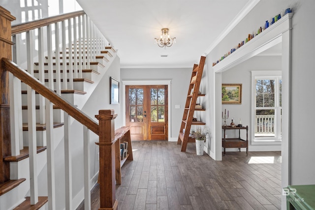 entrance foyer featuring crown molding, dark wood-style floors, baseboards, and a healthy amount of sunlight