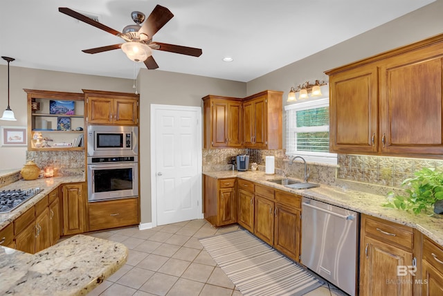 kitchen featuring a sink, tasteful backsplash, a ceiling fan, appliances with stainless steel finishes, and light tile patterned floors