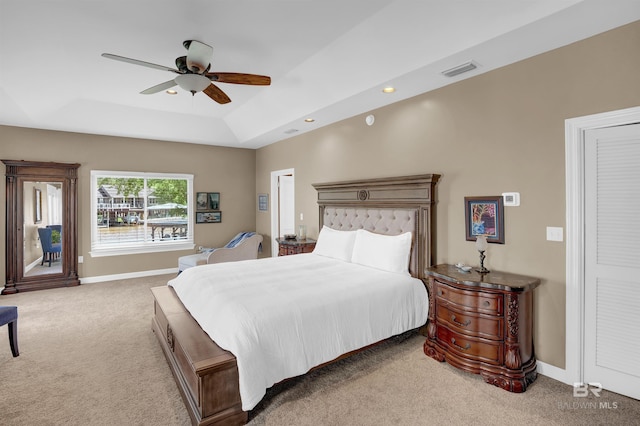 carpeted bedroom with a ceiling fan, access to exterior, visible vents, a raised ceiling, and baseboards