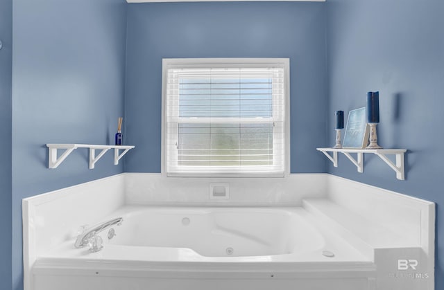 full bath featuring a healthy amount of sunlight and a tub with jets