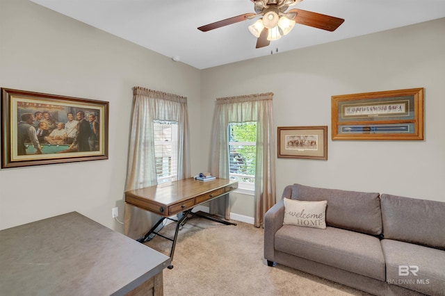office area featuring light colored carpet, baseboards, and ceiling fan