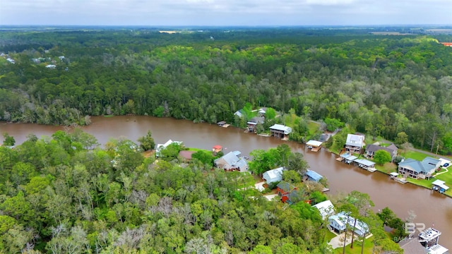 birds eye view of property with a water view, a residential view, and a wooded view