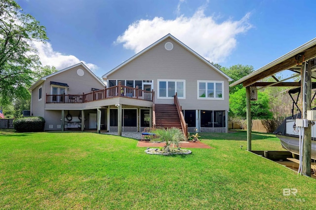 rear view of property with a lawn, fence, a wooden deck, and stairs