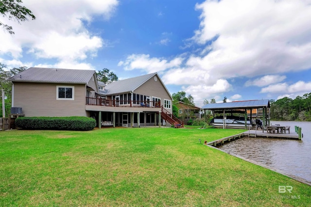 rear view of house featuring metal roof, boat lift, a yard, a water view, and stairs