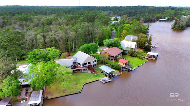 drone / aerial view featuring a water view and a wooded view