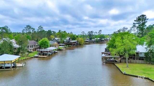water view with boat lift, fence, a residential view, and a boat dock