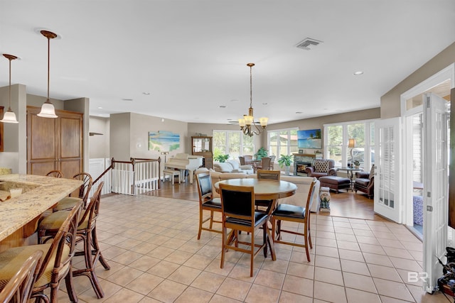 dining space featuring a chandelier, recessed lighting, light tile patterned flooring, and visible vents