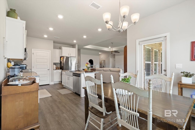 10487 Sand Dune Ave, Mobile, AL 36695 - dining room featuring recessed lighting, dark wood-style floors, a chandelier, a tray ceiling, and crown molding