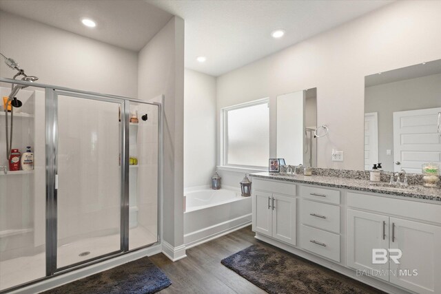 10487 Sand Dune Ave, Mobile, AL 36695 - full bath featuring a stall shower, wood finished floors, a garden tub, double vanity, and recessed lighting