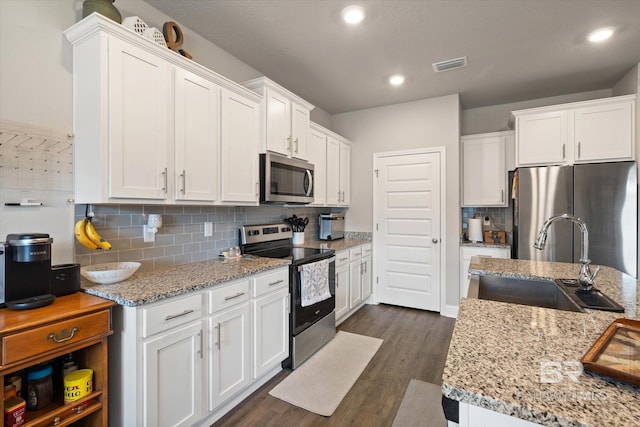 10487 Sand Dune Ave, Mobile, AL 36695 - kitchen featuring stainless steel appliances, a sink, white cabinets, dark wood-style flooring, and recessed lighting