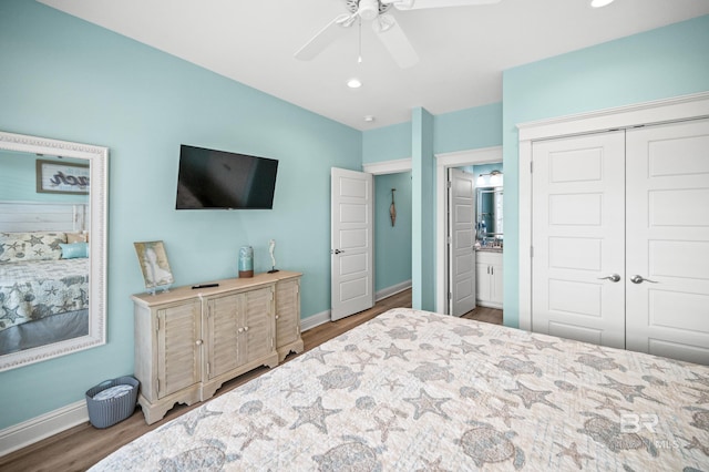 bedroom with dark wood-type flooring, ceiling fan, and a closet