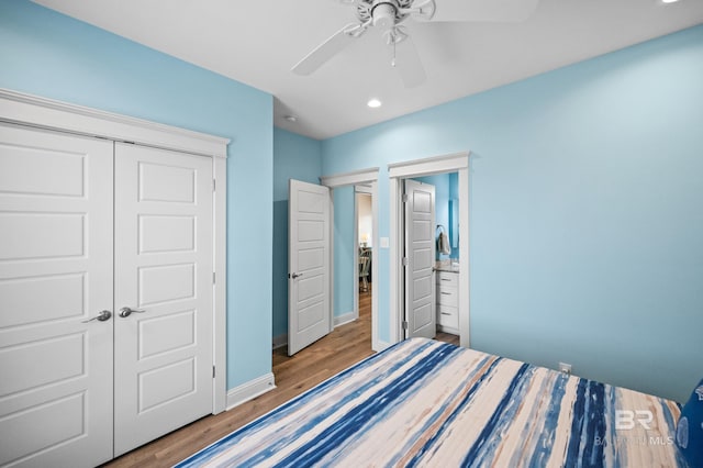 bedroom with wood-type flooring, ceiling fan, and a closet