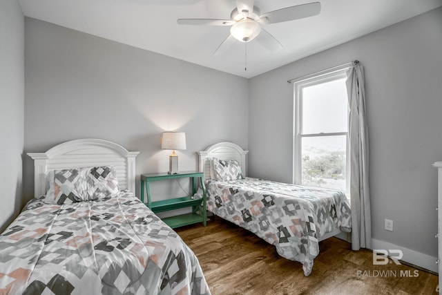 bedroom featuring dark wood-type flooring and ceiling fan