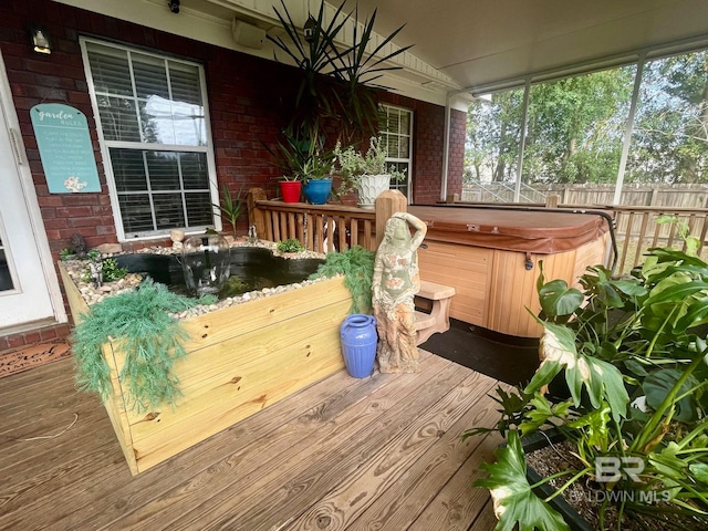 wooden deck featuring a hot tub