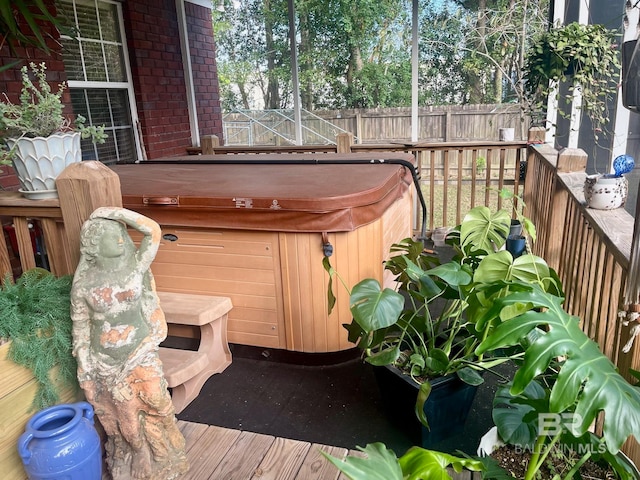 wooden terrace with a hot tub