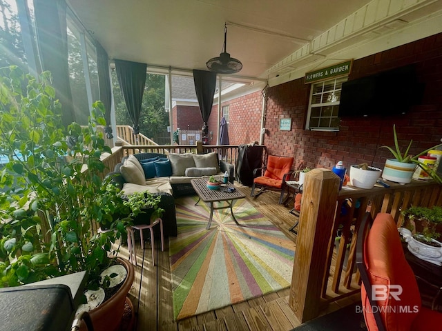 view of patio featuring outdoor lounge area, ceiling fan, and a wooden deck